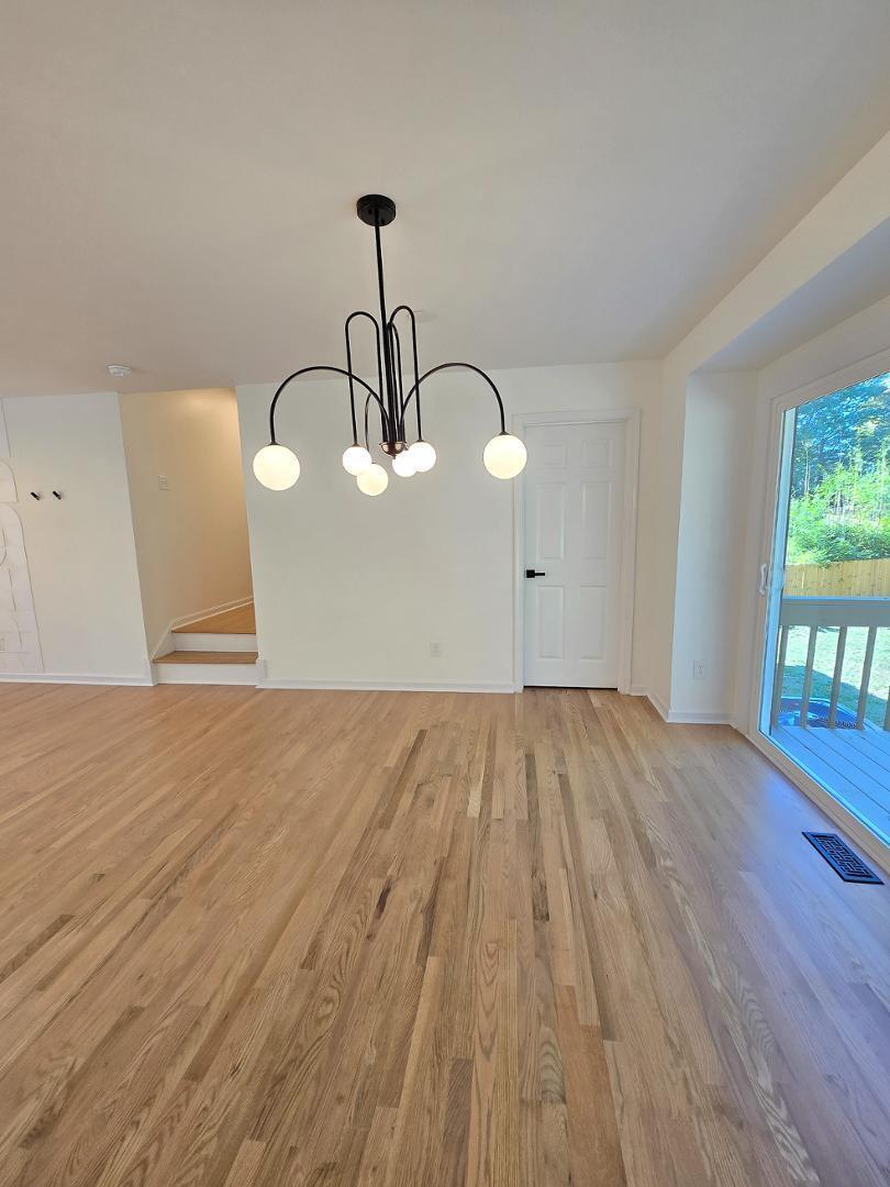 1105 Hardimont Road Raleigh, NC 27609 - Photo 13 of 61 a view of empty room with wooden floor and fan