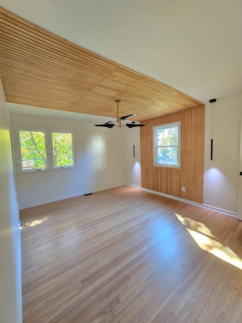 1105 Hardimont Road Raleigh, NC 27609 - Photo 15 of 61 an empty room with wooden floor and windows