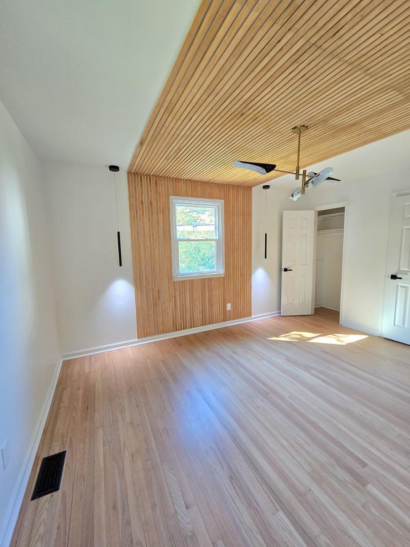 1105 Hardimont Road Raleigh, NC 27609 - Photo 16 of 61 a view of empty room with wooden floor and fan