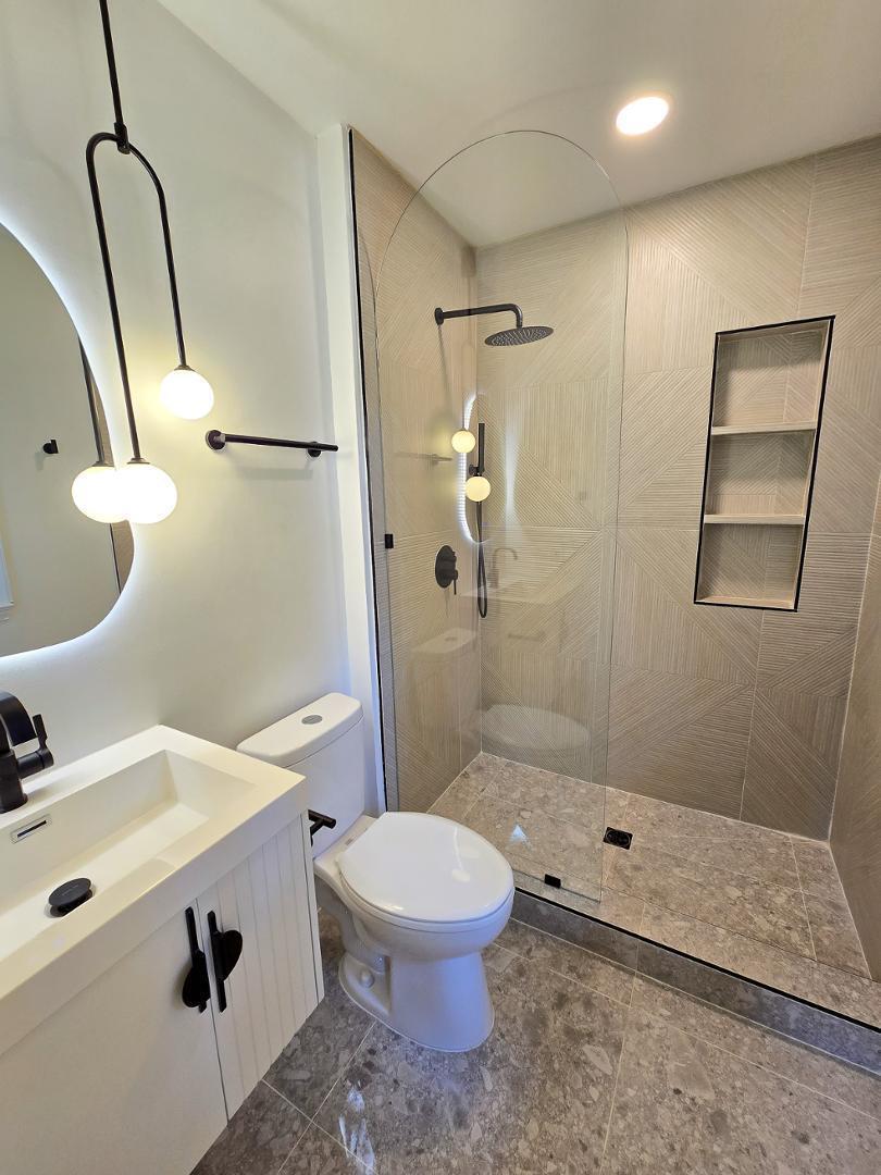 1105 Hardimont Road Raleigh, NC 27609 - Photo 20 of 61 a bathroom with a sink a toilet and shower
