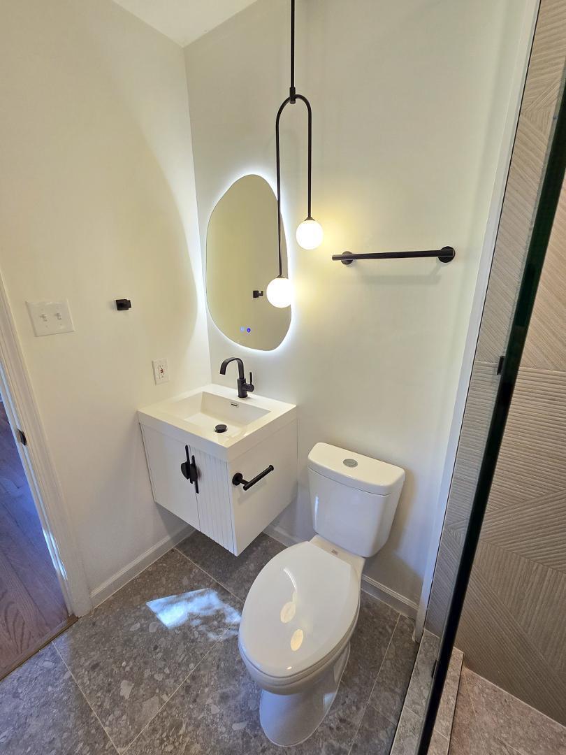 1105 Hardimont Road Raleigh, NC 27609 - Photo 22 of 61 a bathroom with a toilet sink and mirror