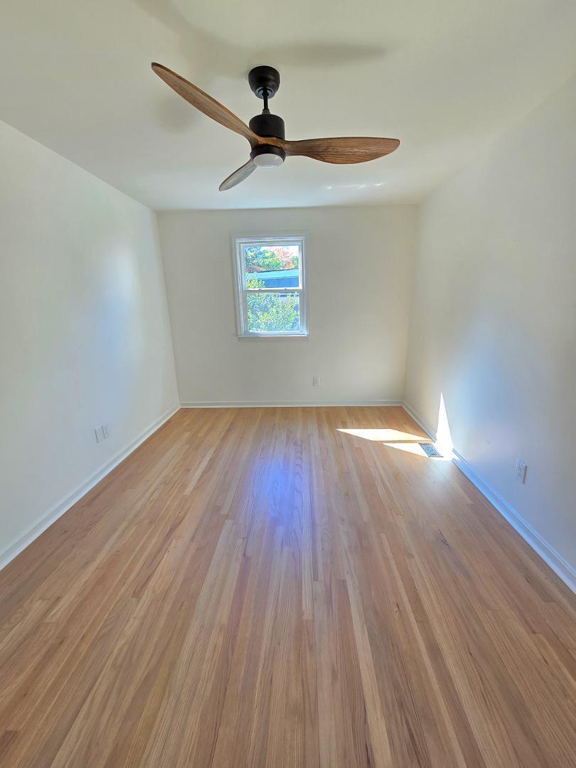 1105 Hardimont Road Raleigh, NC 27609 - Photo 25 of 61 a view of empty room with wooden floor and fan