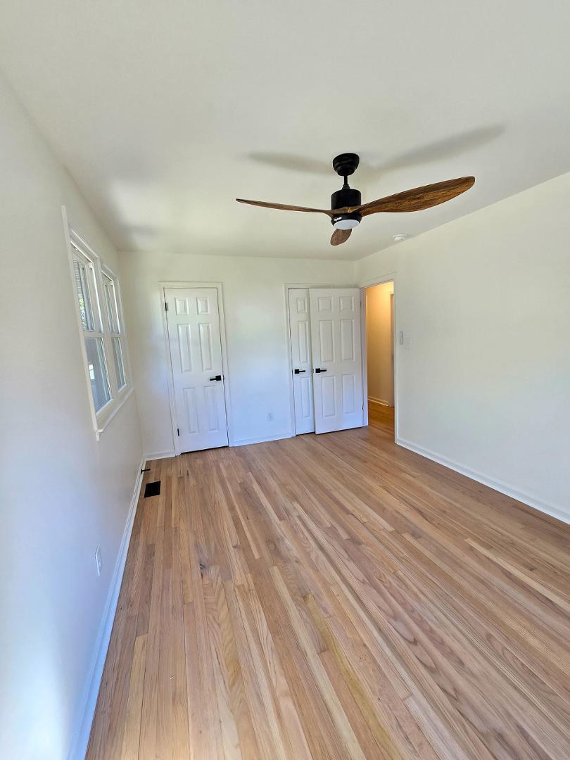 1105 Hardimont Road Raleigh, NC 27609 - Photo 26 of 61 a view of empty room with wooden floor and fan