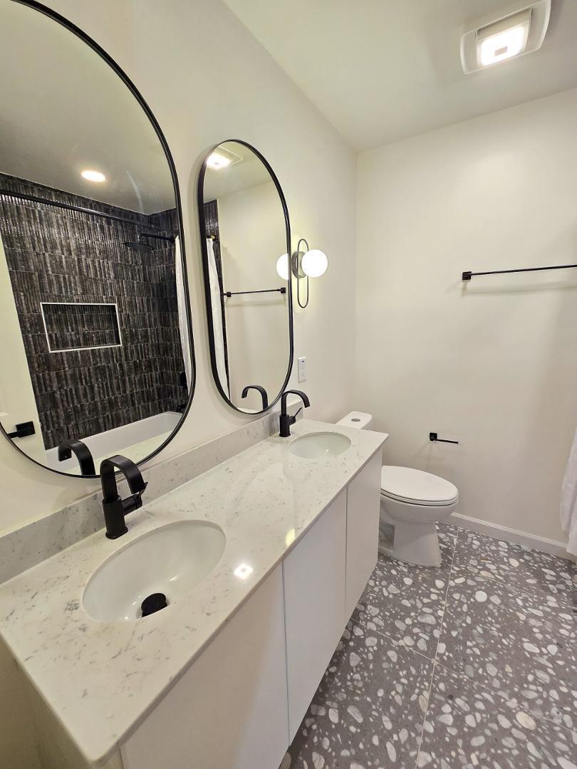 1105 Hardimont Road Raleigh, NC 27609 - Photo 37 of 61 a bathroom with a sink a toilet and a mirror