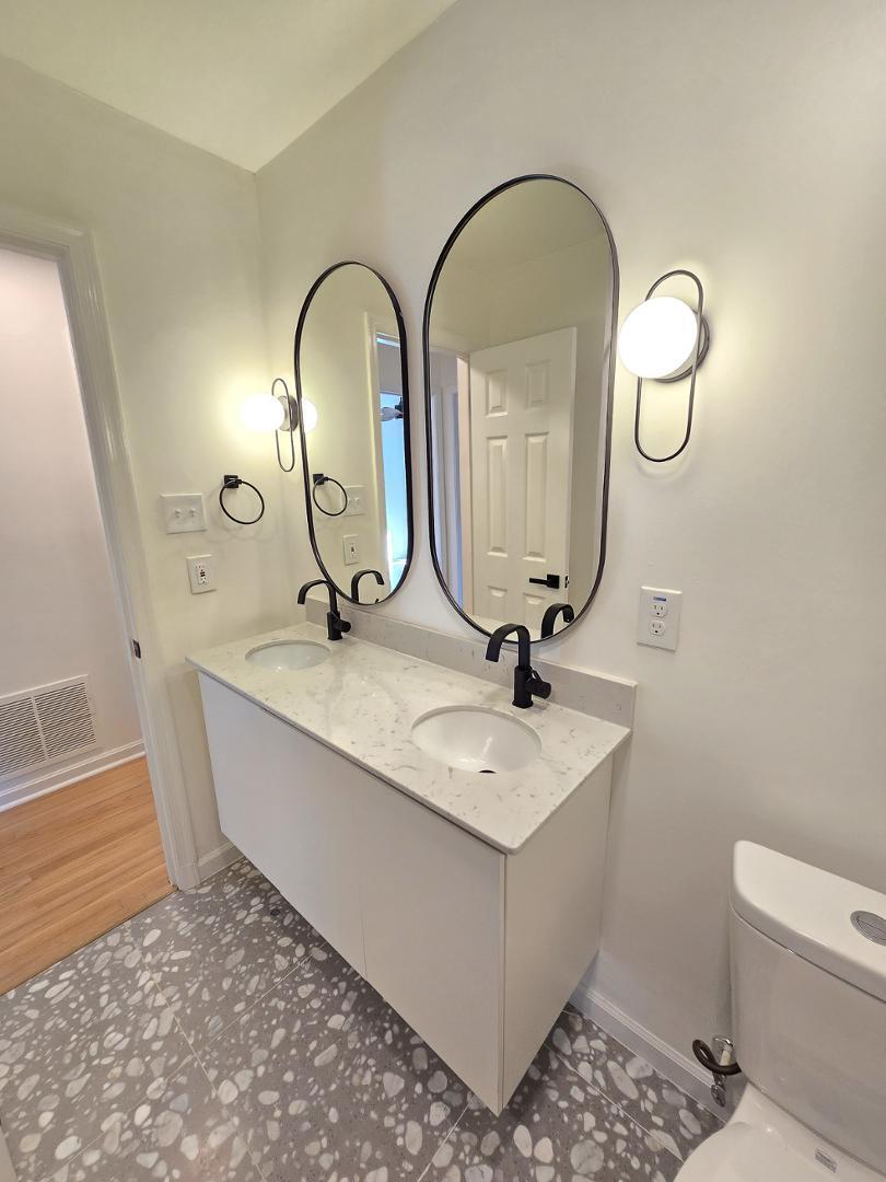 1105 Hardimont Road Raleigh, NC 27609 - Photo 39 of 61 a bathroom with a sink and a mirror