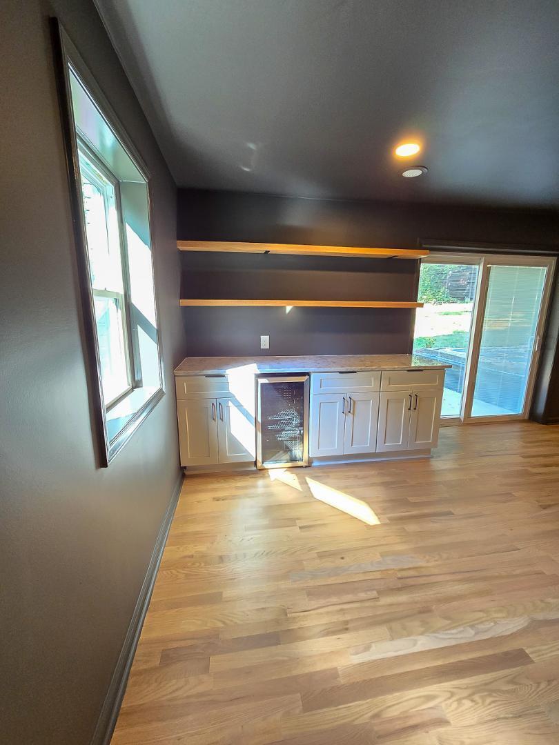 1105 Hardimont Road Raleigh, NC 27609 - Photo 42 of 61 a view of an empty room with wooden floor and a window