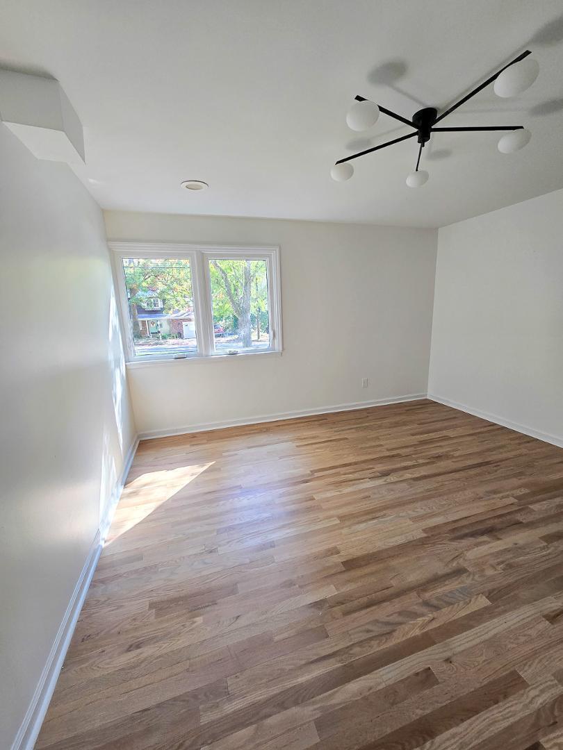 1105 Hardimont Road Raleigh, NC 27609 - Photo 45 of 61 wooden floor in an empty room with a window