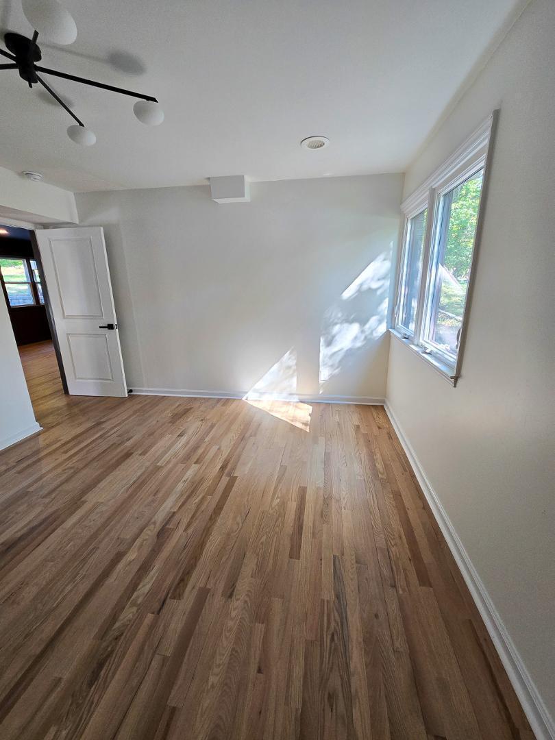 1105 Hardimont Road Raleigh, NC 27609 - Photo 48 of 61 a view of empty room with wooden floor and fan