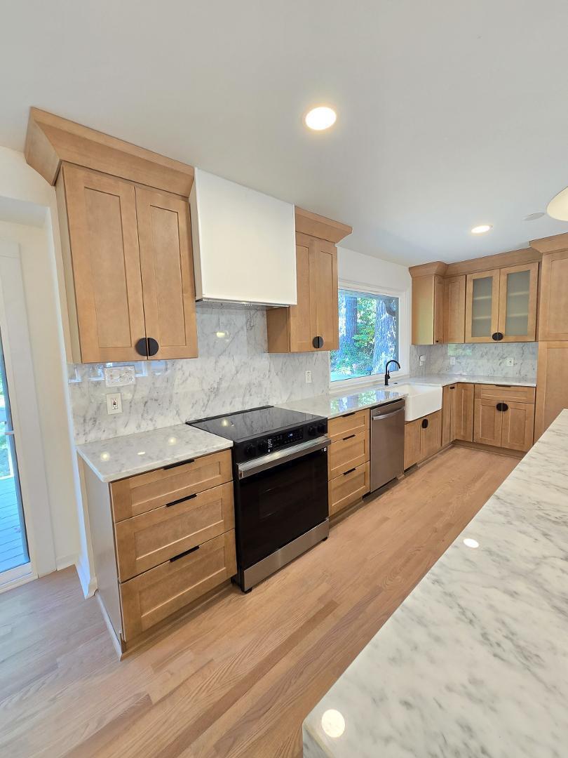1105 Hardimont Road Raleigh, NC 27609 - Photo 9 of 61 a large kitchen with stainless steel appliances granite countertop a stove and a sink