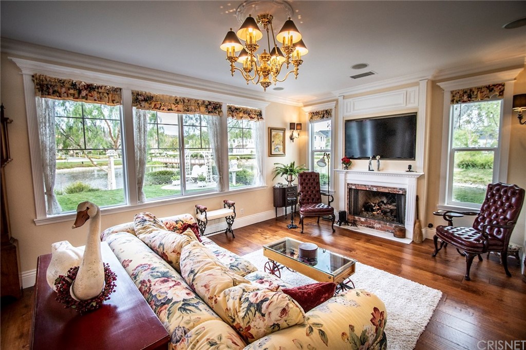 27016 Island Road Valencia, CA 91355 - Photo 2 of 53 a living room with furniture a fireplace and a flat screen tv