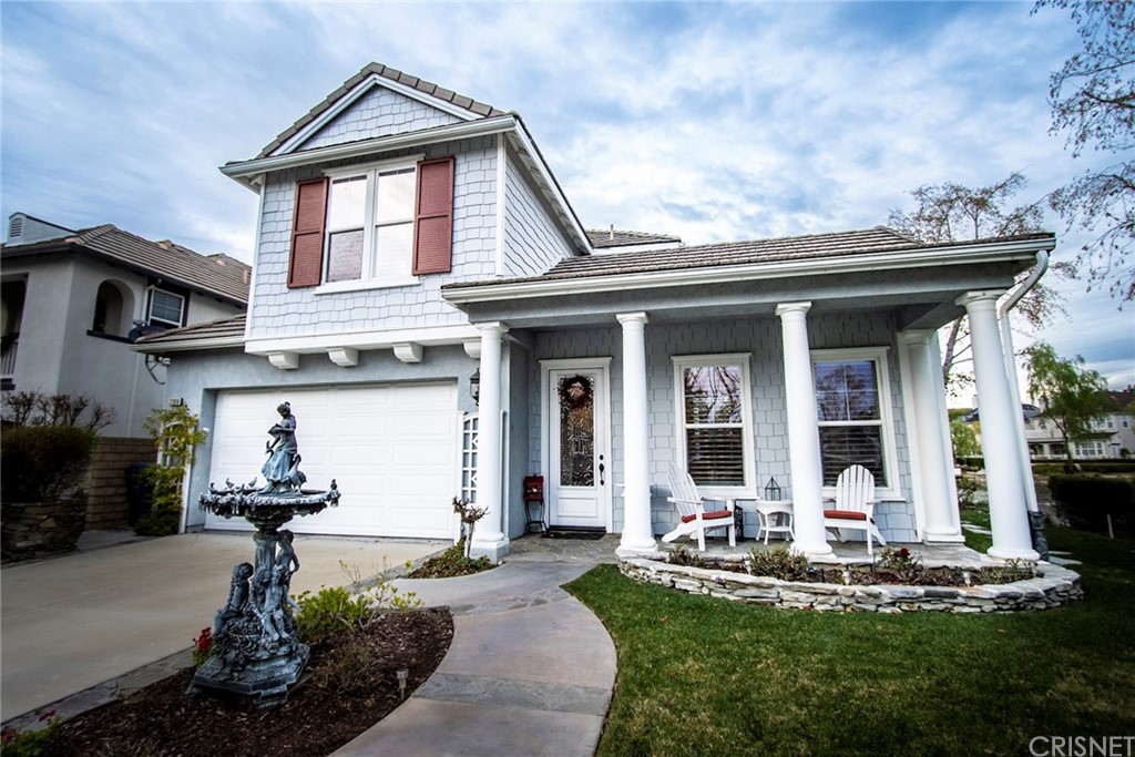 27016 Island Road Valencia, CA 91355 - Photo 3 of 53 a front view of a house with swimming pool and porch
