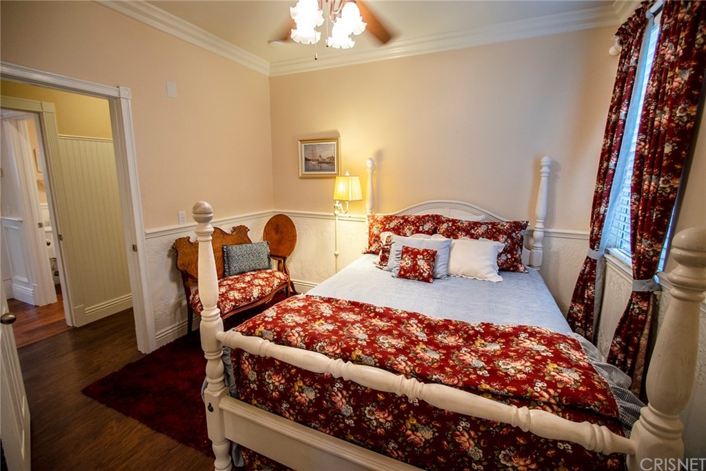 27016 Island Road Valencia, CA 91355 - Photo 39 of 53 a bedroom with a bed and wooden floor