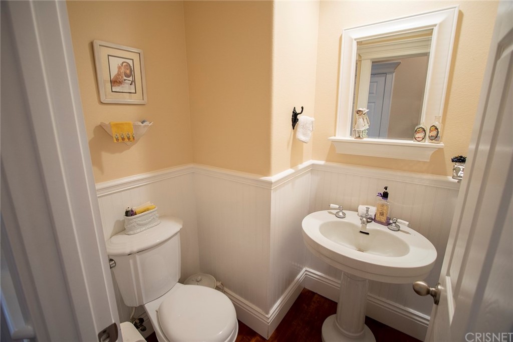 27016 Island Road Valencia, CA 91355 - Photo 40 of 53 a bathroom with a sink mirror and a toilet