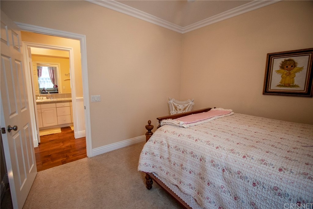 27016 Island Road Valencia, CA 91355 - Photo 42 of 53 a bedroom with a bed and wooden floor
