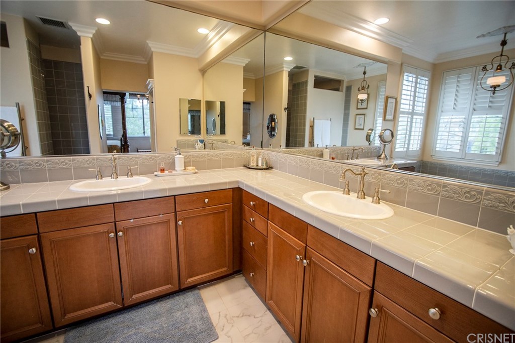 27016 Island Road Valencia, CA 91355 - Photo 50 of 53 a bathroom with double vanity sinks and a large mirror