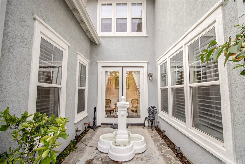 27016 Island Road Valencia, CA 91355 - Photo 9 of 53 a view of a patio with table and chairs and potted plants