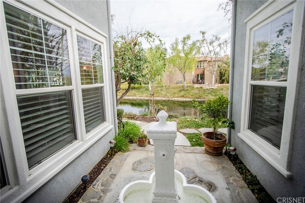27016 Island Road Valencia, CA 91355 - Photo 10 of 53 a view of a porch with furniture and floor to ceiling window