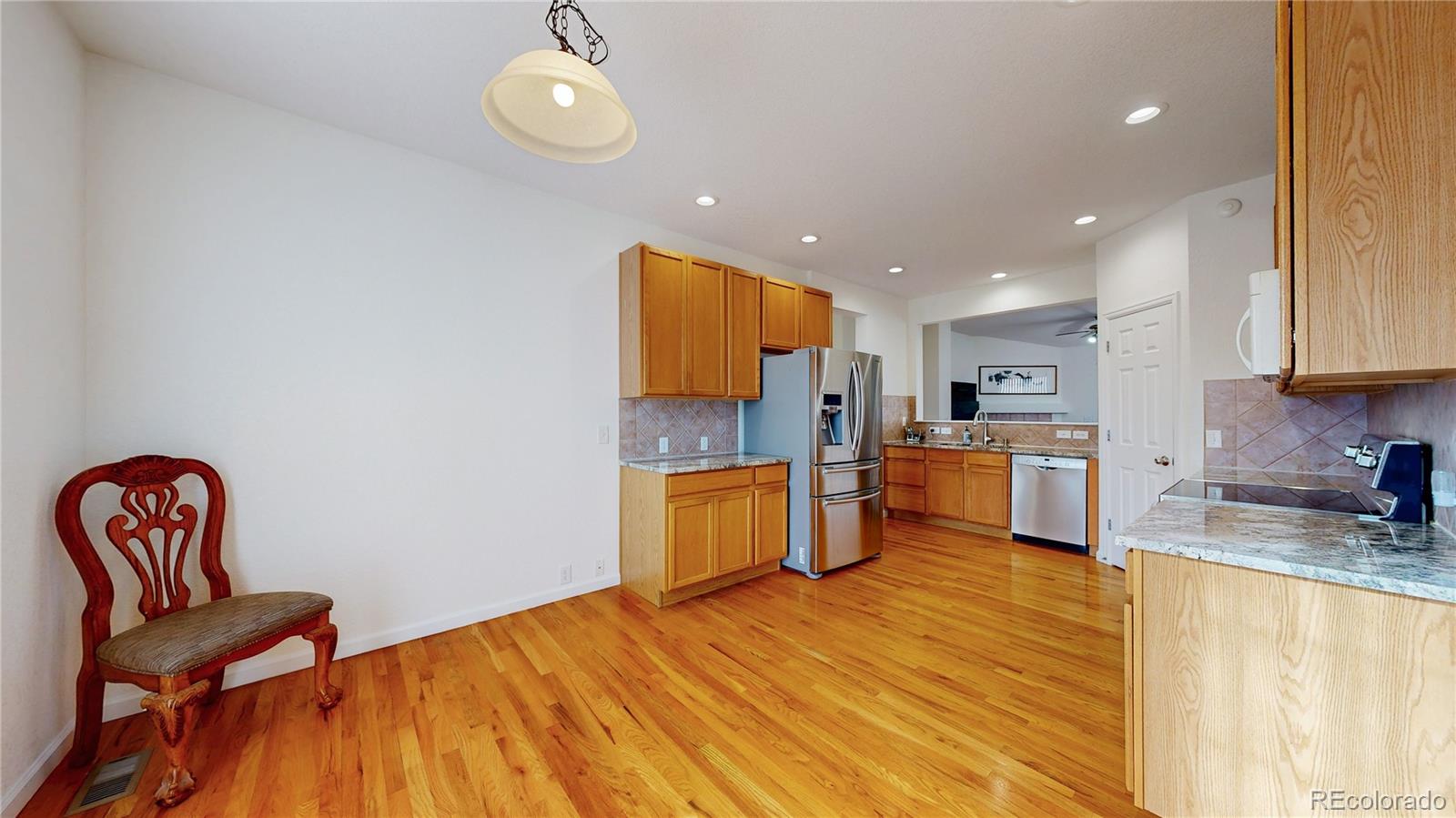 12237 Cook Court Thornton, CO 80241 - Photo 11 of 48 a kitchen with stainless steel appliances granite countertop a refrigerator and a stove top oven
