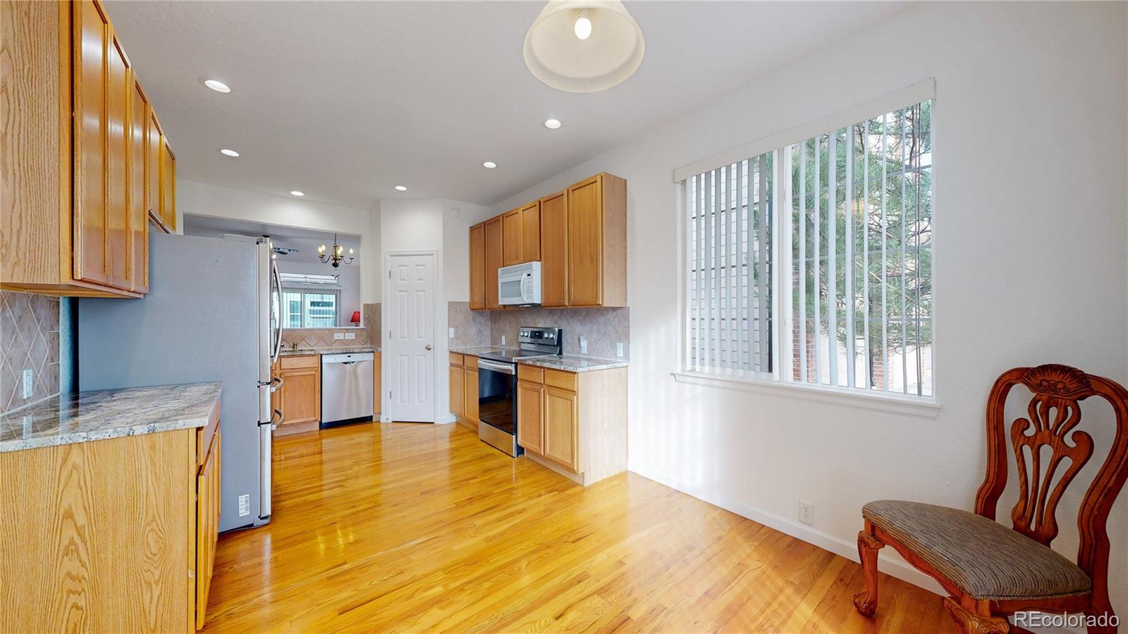 12237 Cook Court Thornton, CO 80241 - Photo 12 of 48 a kitchen with a refrigerator and a sink