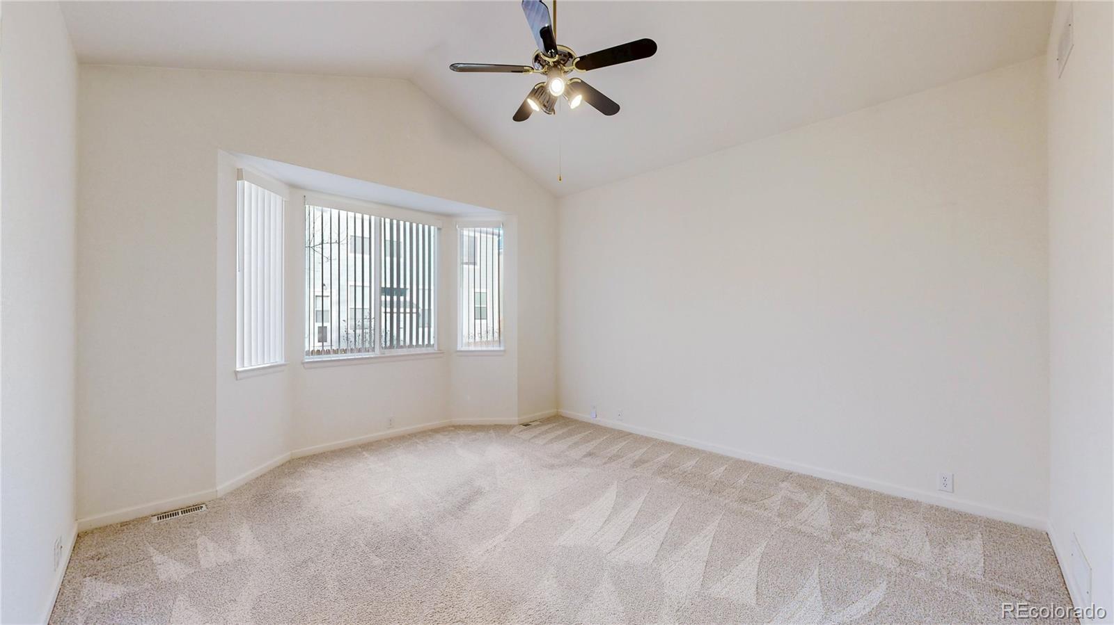 12237 Cook Court Thornton, CO 80241 - Photo 14 of 48 an empty room with windows and fan