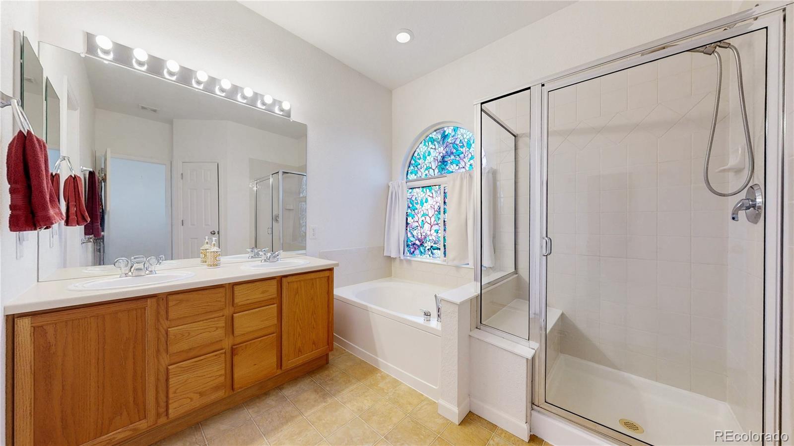 12237 Cook Court Thornton, CO 80241 - Photo 18 of 48 a bathroom with a tub sink and mirror