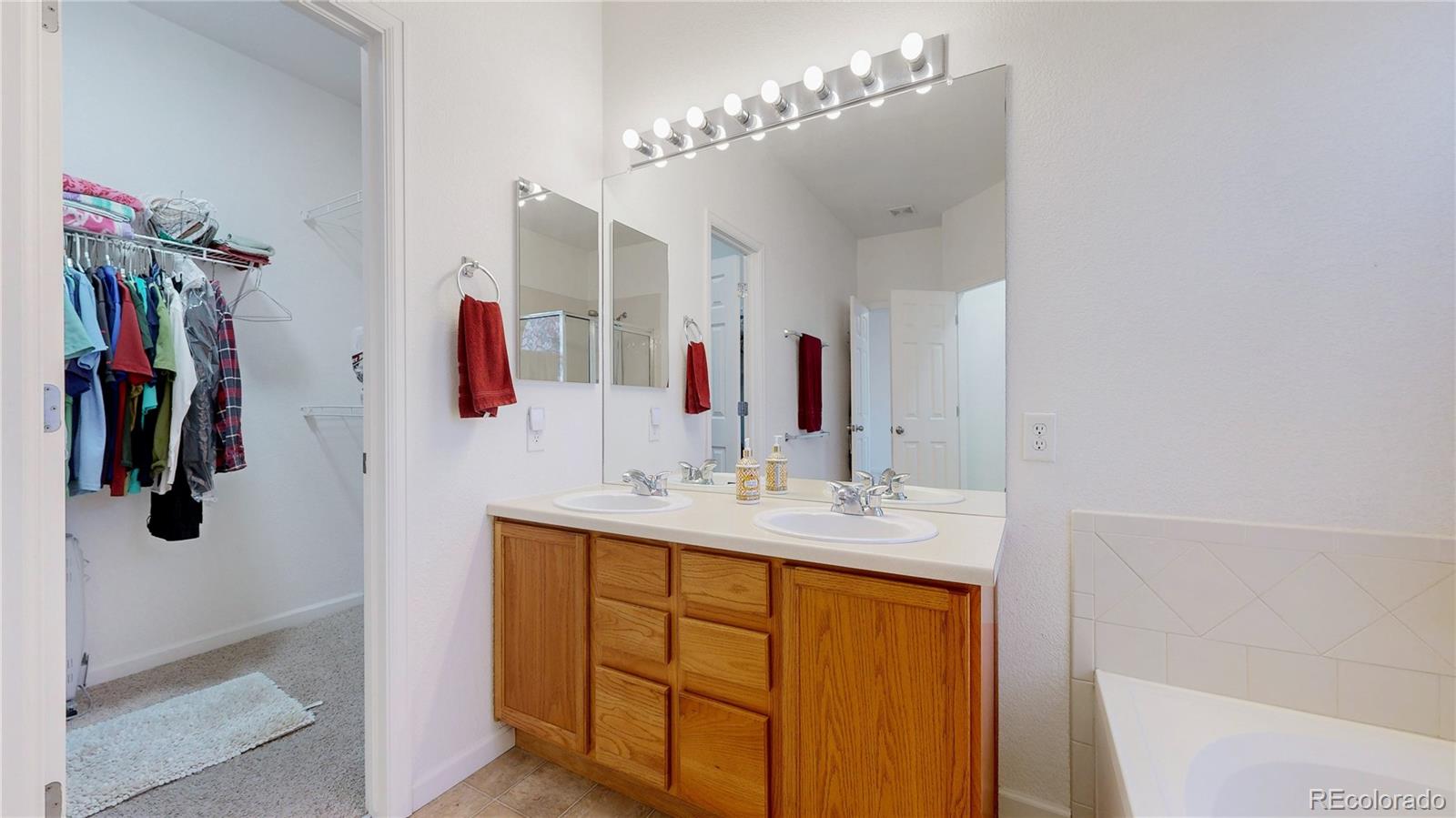 12237 Cook Court Thornton, CO 80241 - Photo 20 of 48 a bathroom with a sink vanity and a mirror
