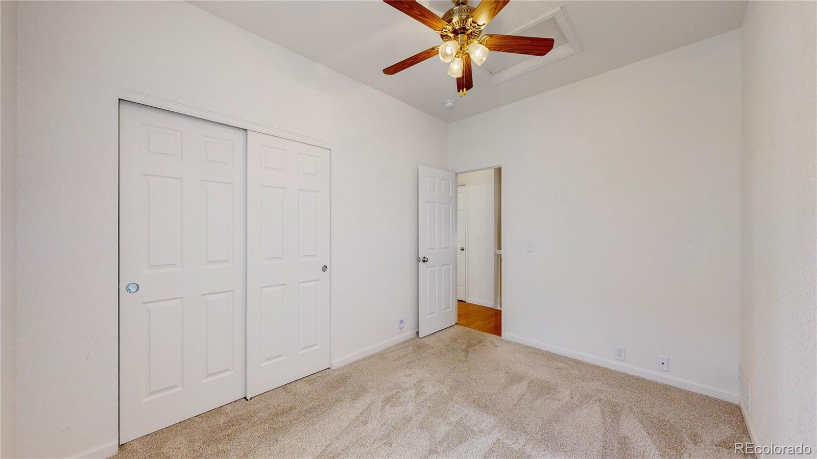 12237 Cook Court Thornton, CO 80241 - Photo 27 of 48 an empty room with a chandelier fan and closet