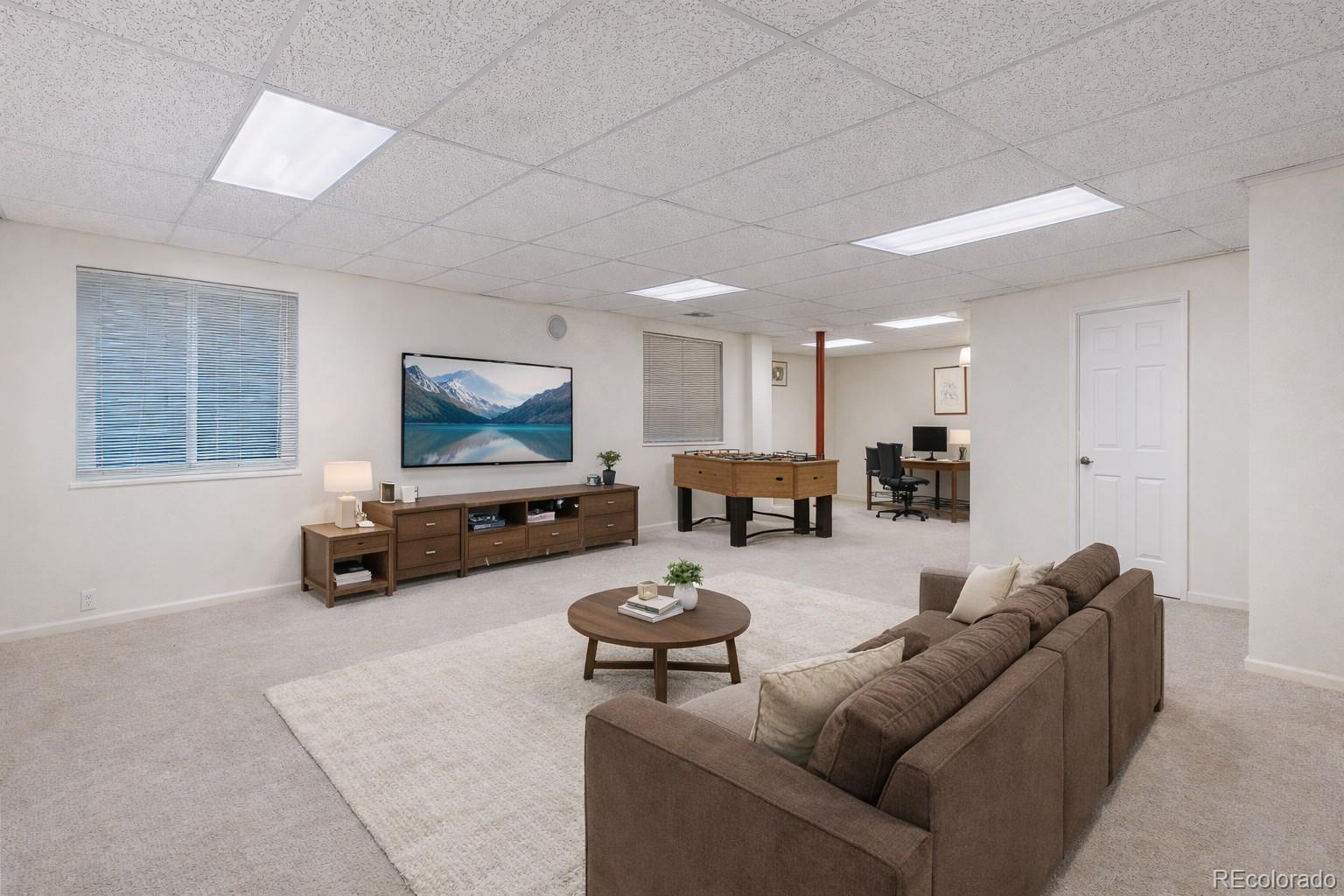 12237 Cook Court Thornton, CO 80241 - Photo 29 of 48 a living room with furniture a pool and a couch