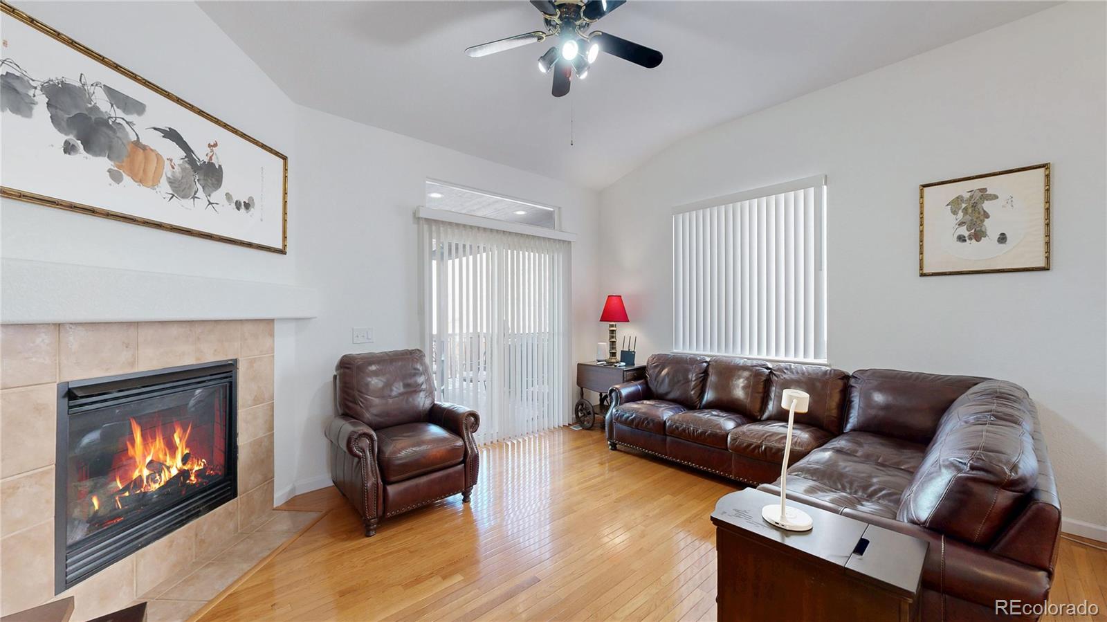 12237 Cook Court Thornton, CO 80241 - Photo 3 of 48 a living room with furniture and a fireplace