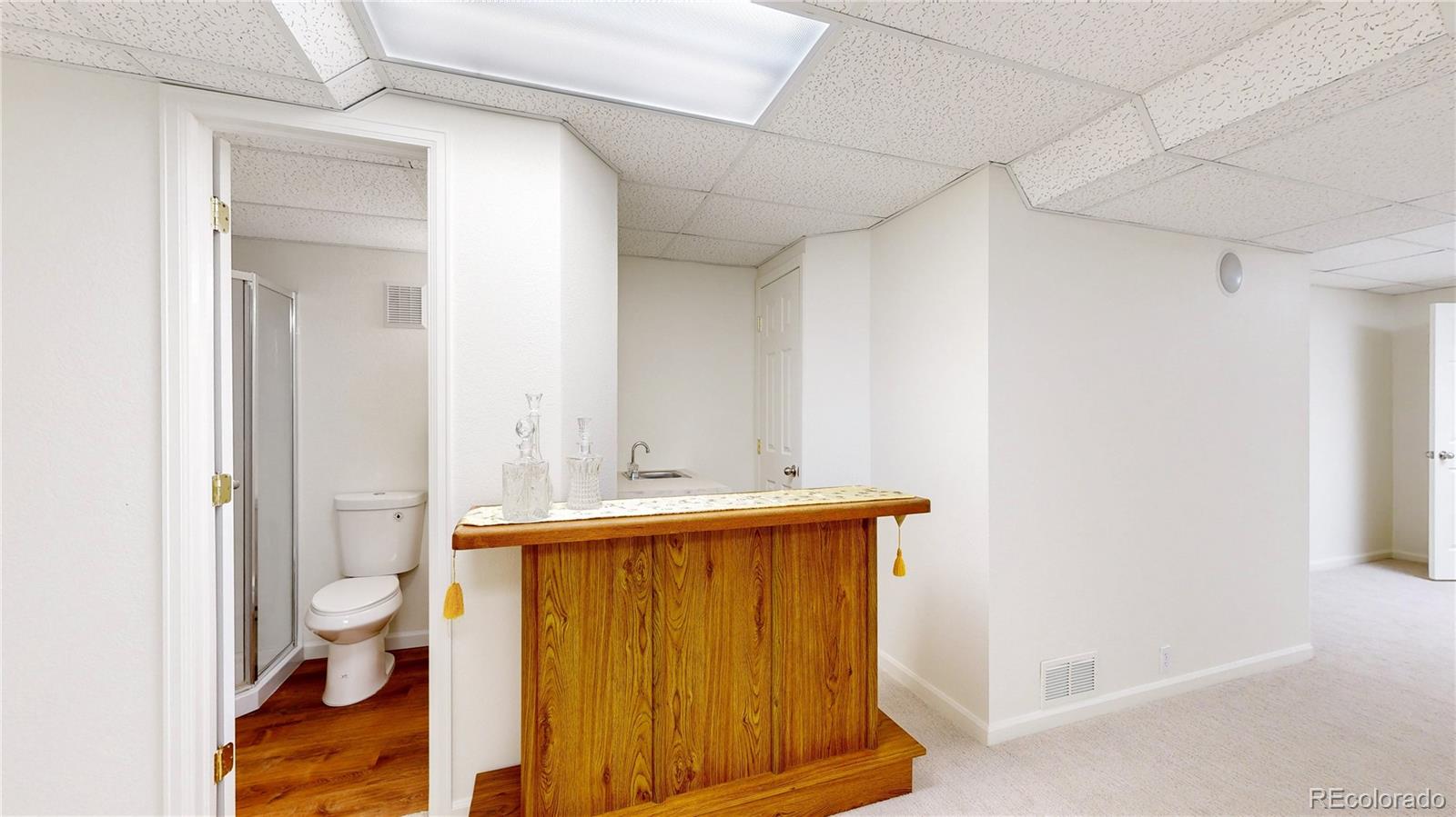 12237 Cook Court Thornton, CO 80241 - Photo 33 of 48 a bathroom with a sink a toilet and shower