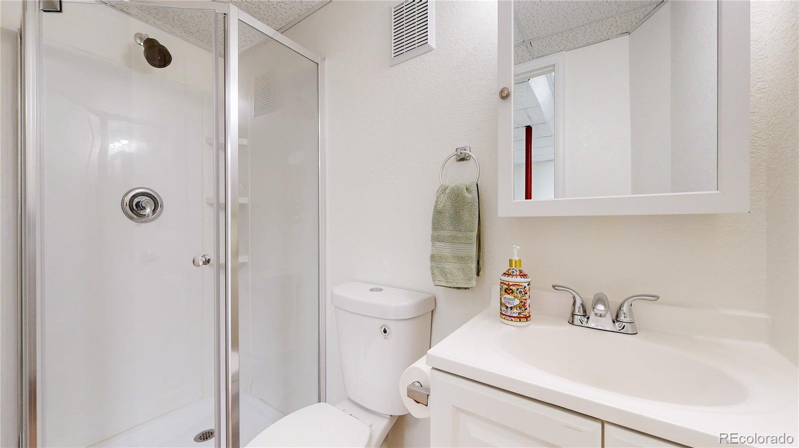 12237 Cook Court Thornton, CO 80241 - Photo 34 of 48 a bathroom with a sink toilet and shower