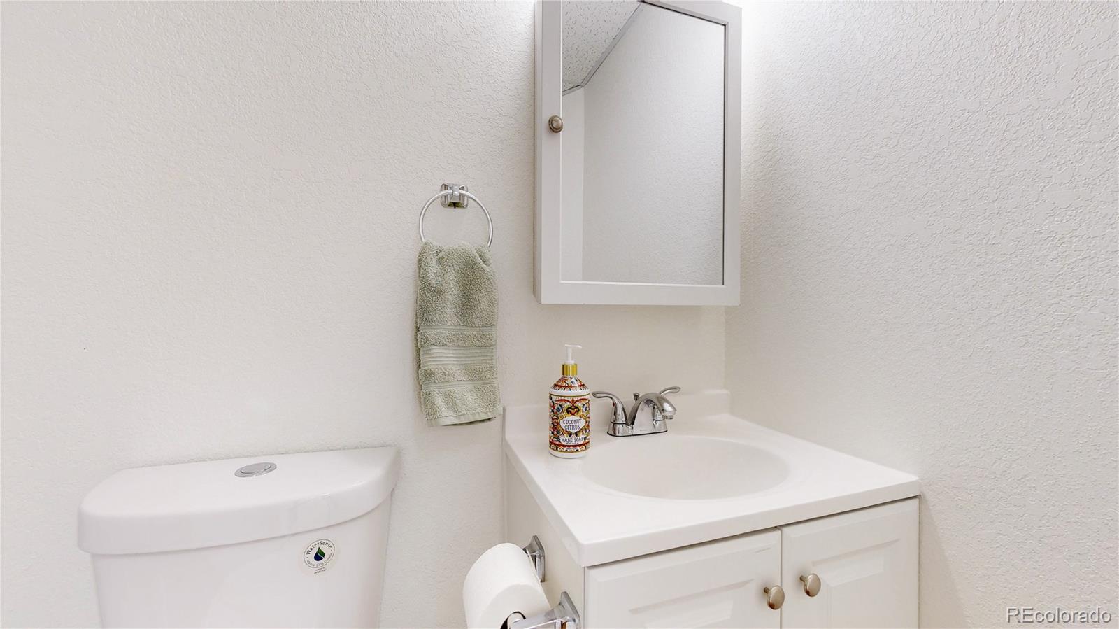 12237 Cook Court Thornton, CO 80241 - Photo 35 of 48 a bathroom with a sink a toilet and vanity