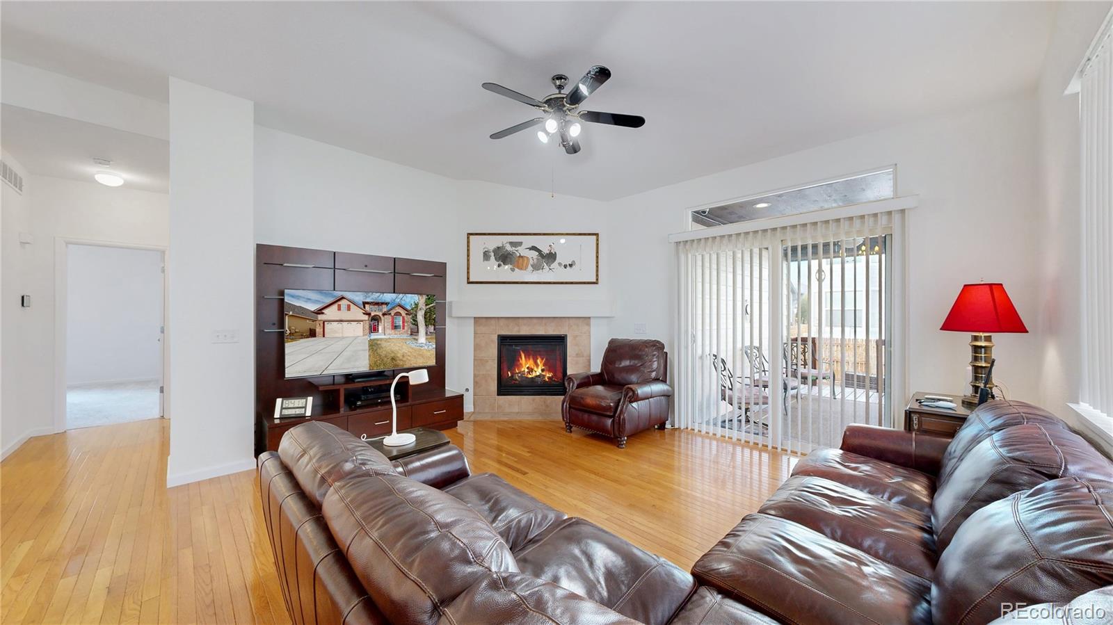 12237 Cook Court Thornton, CO 80241 - Photo 4 of 48 a living room with furniture flower pot and a fireplace