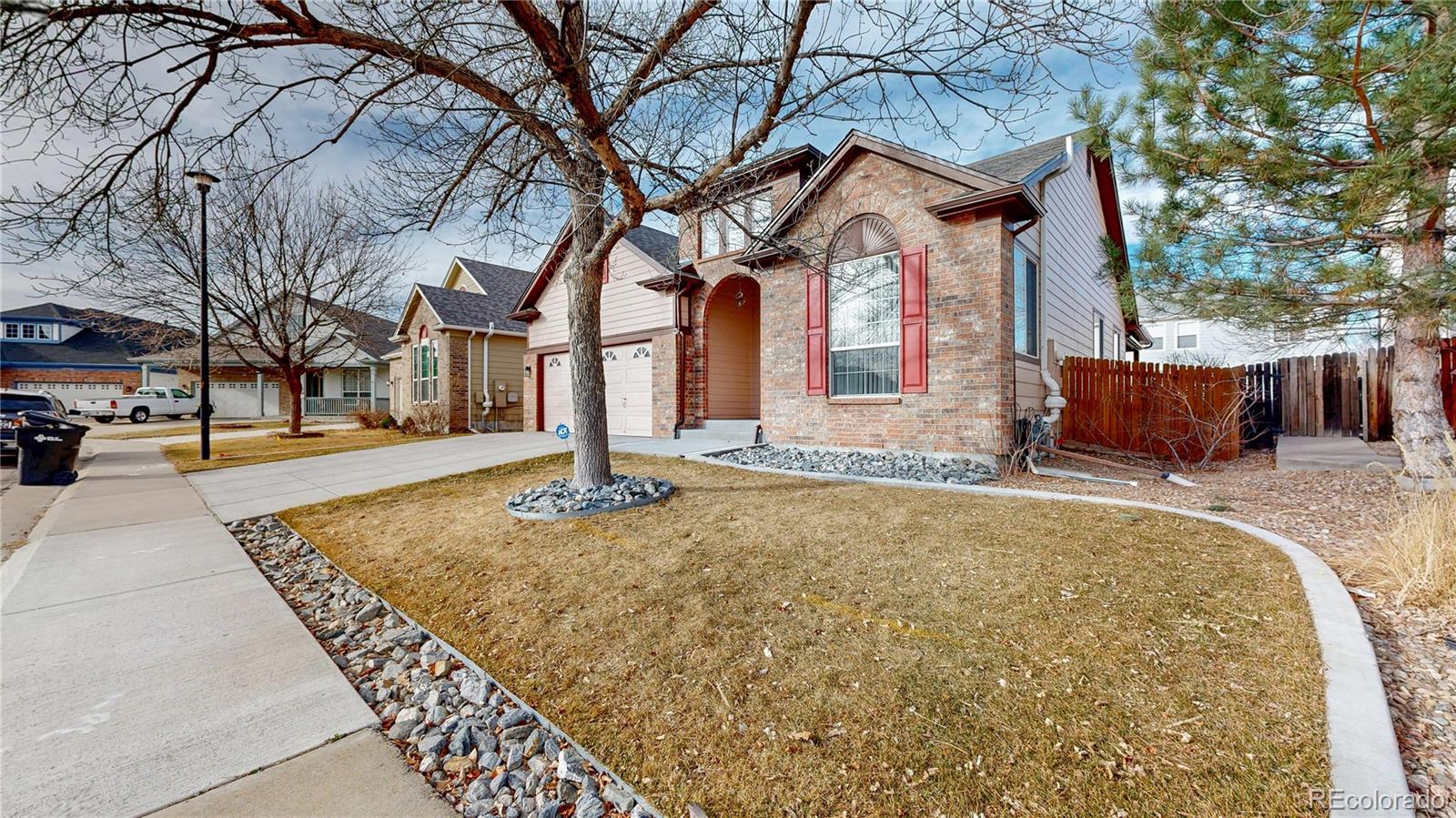 12237 Cook Court Thornton, CO 80241 - Photo 42 of 48 a front view of a house with a yard