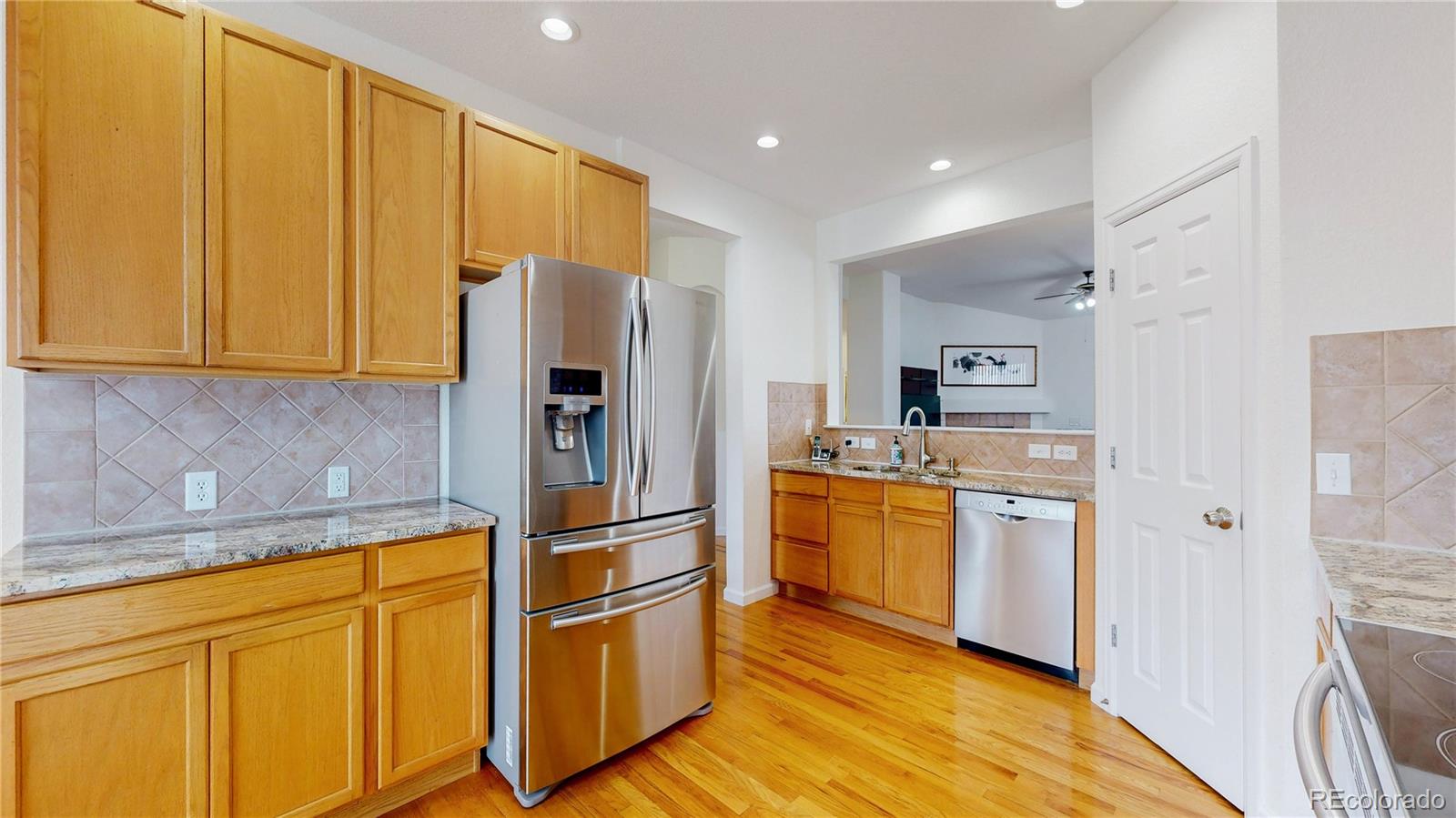 12237 Cook Court Thornton, CO 80241 - Photo 9 of 48 a kitchen with stainless steel appliances granite countertop a refrigerator and a stove top oven