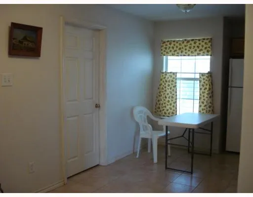 a view of a room that has a window and table in it