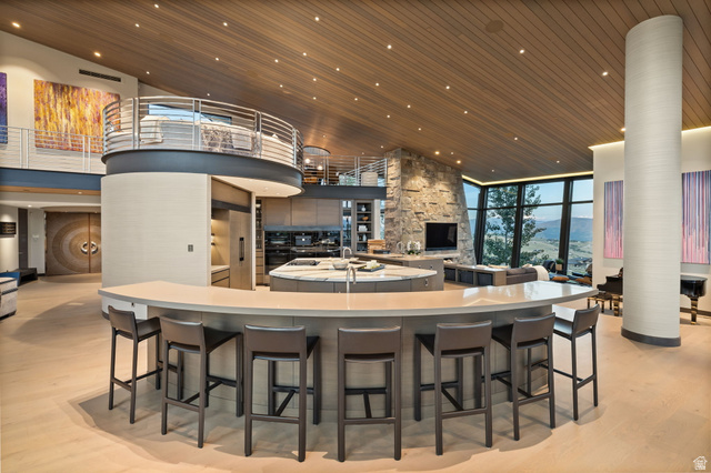 8544 North Promontory Ranch Road Park City, UT 84098 - Photo 6 of 36 Kitchen with a high wooden ceiling, recessed lighting, a fireplace, floor to ceiling windows, and a breakfast bar area