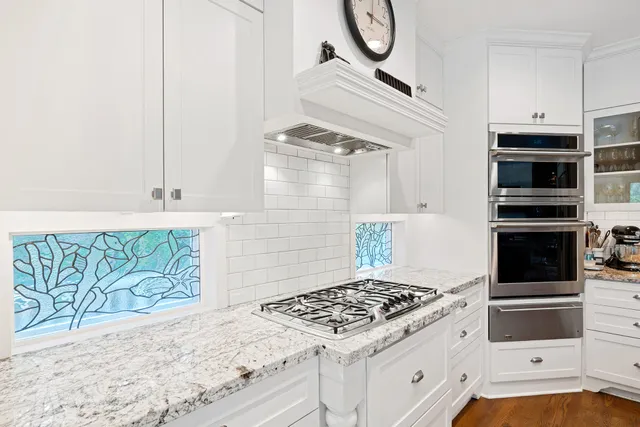 a kitchen with granite countertop a stove and a sink