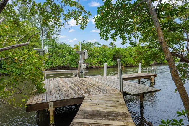a view of backyard with wooden floor and outdoor seating