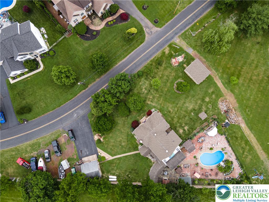 2485 Hieter Road Quakertown, PA 18951 - Photo 88 of 97 An aerial perspective showcases a home with a freeform pool, nestled within a verdant, well-maintained yard.