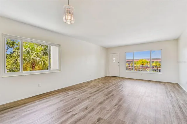 a kitchen with a refrigerator and a stove top oven