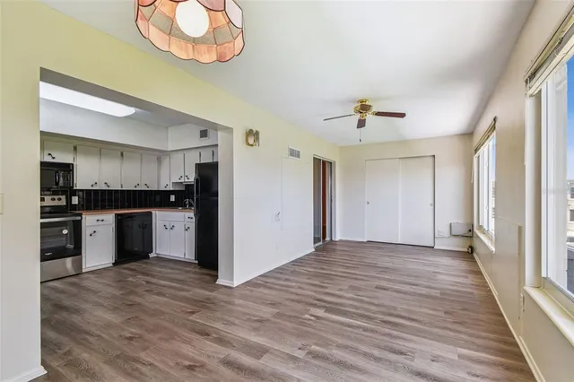 a view of kitchen with wooden floor electronic appliances and window