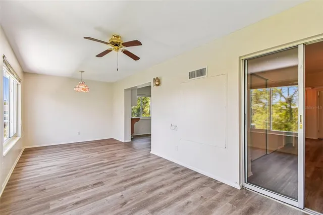 wooden floor in an empty room with a window