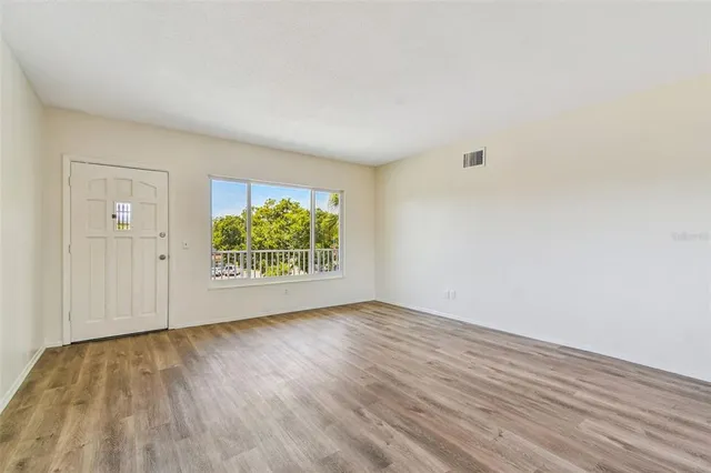 a view of an entryway with wooden floor