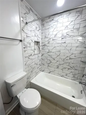 a bathroom with a toilet and a bathtub