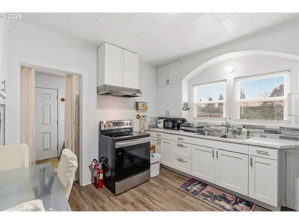 a dining room with furniture and wooden floor