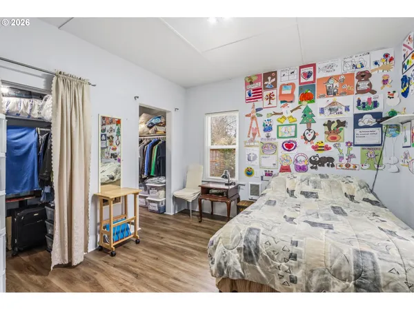a bedroom with a bed and wooden cabinets