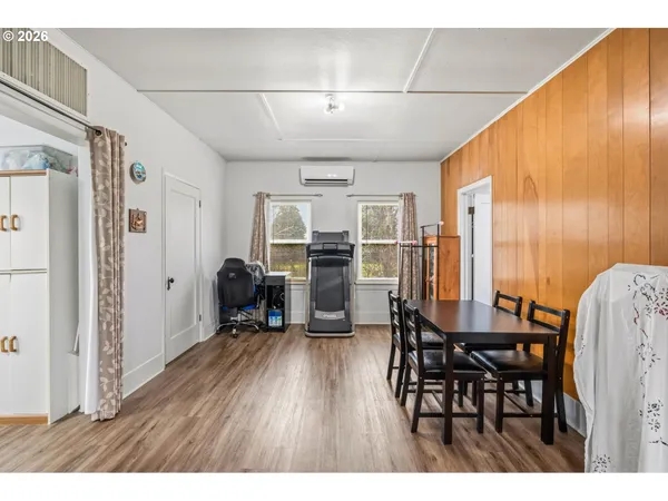 a kitchen with granite countertop a sink cabinets wooden floor and stainless steel appliances