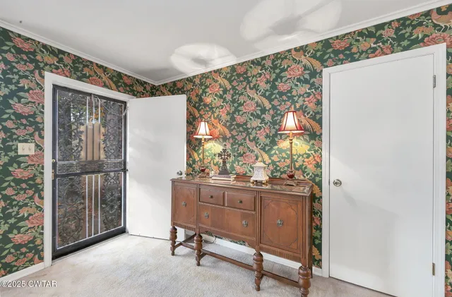 a view of a livingroom with wooden floor and furniture