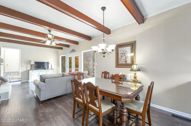 a view of a dining room with furniture wooden floor and chandelier